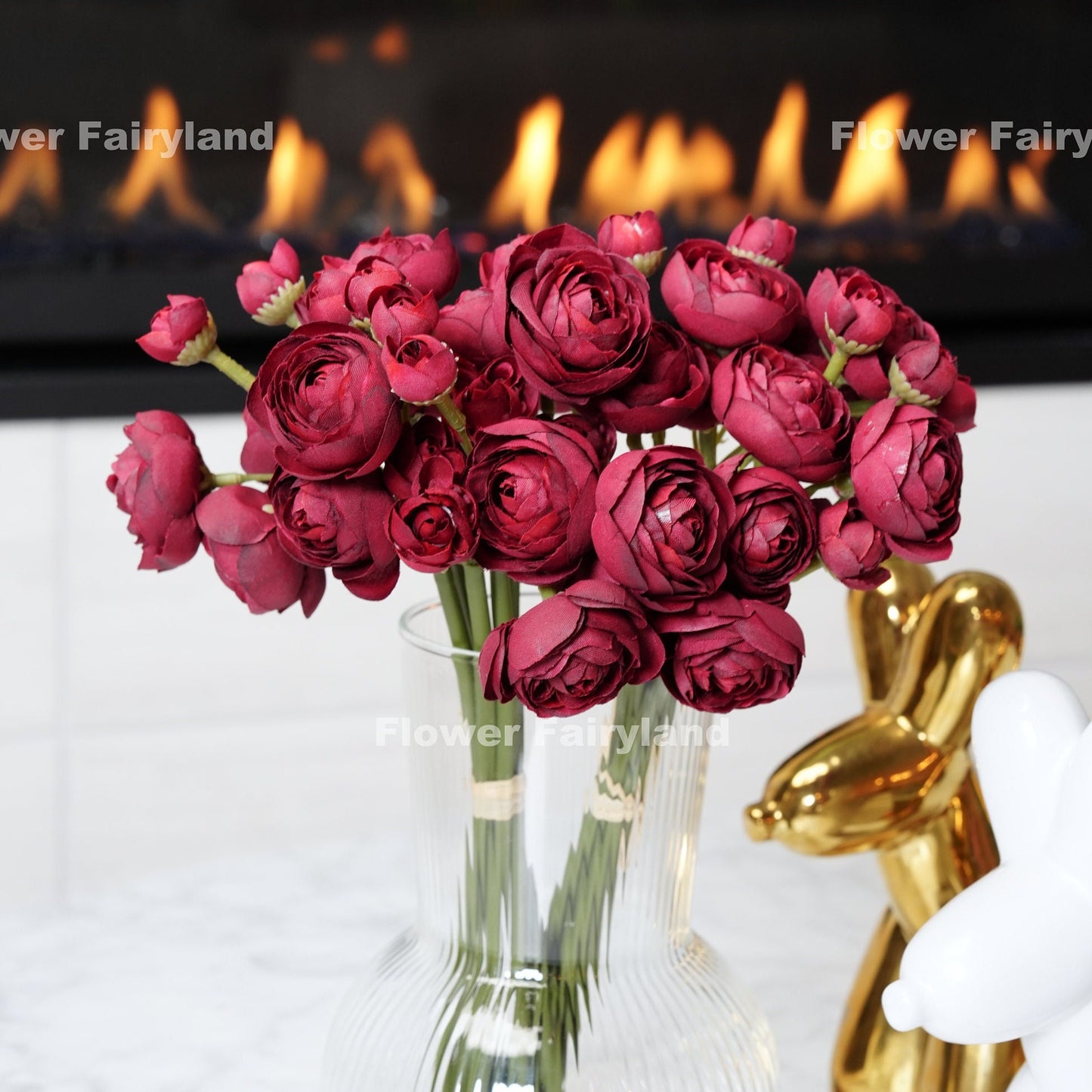 Burgundy ranunculus bundle held in hand
