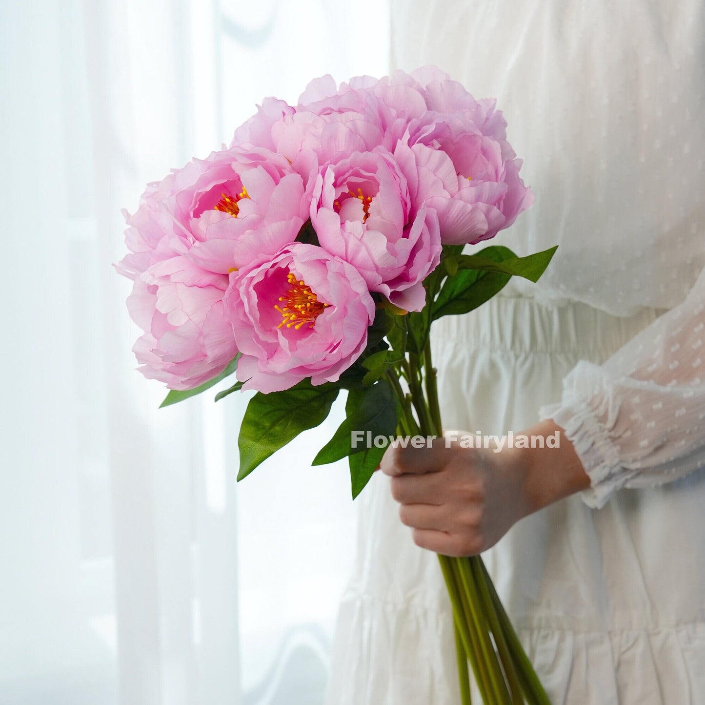Pink faux peony bouquet held in hand