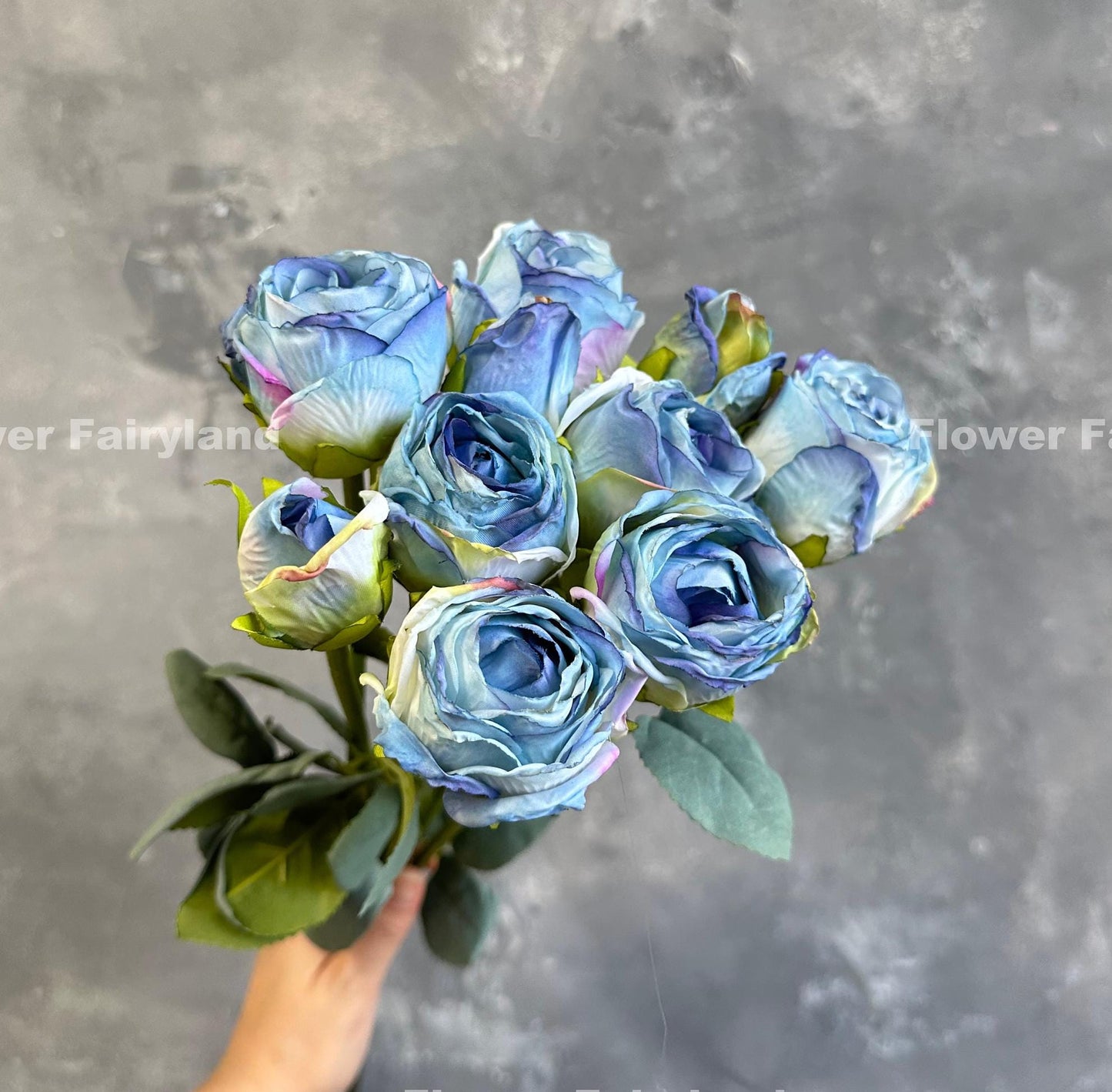 Blue dried look roses in a vase