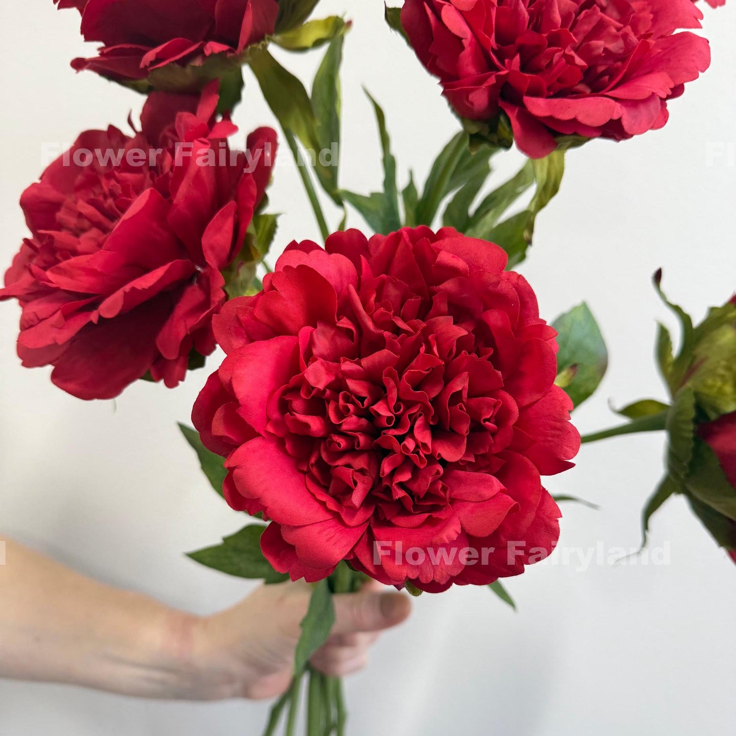 Red faux peony blooms close up