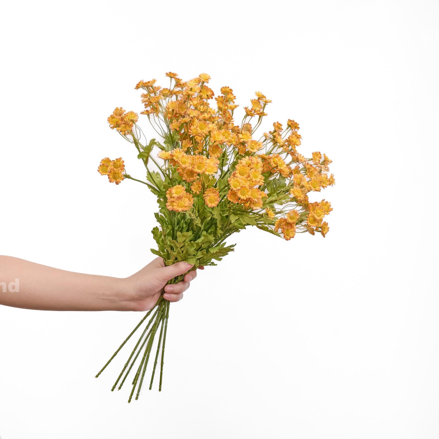 Orange faux chamomile bouquet held in hand