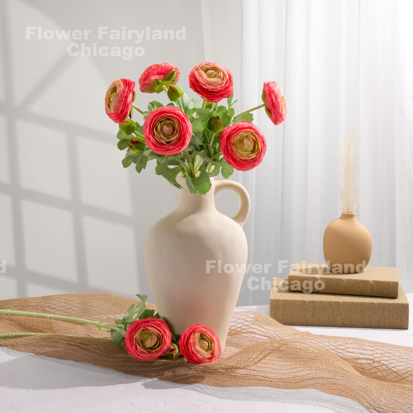 Pink edge faux ranunculus stems in a vase