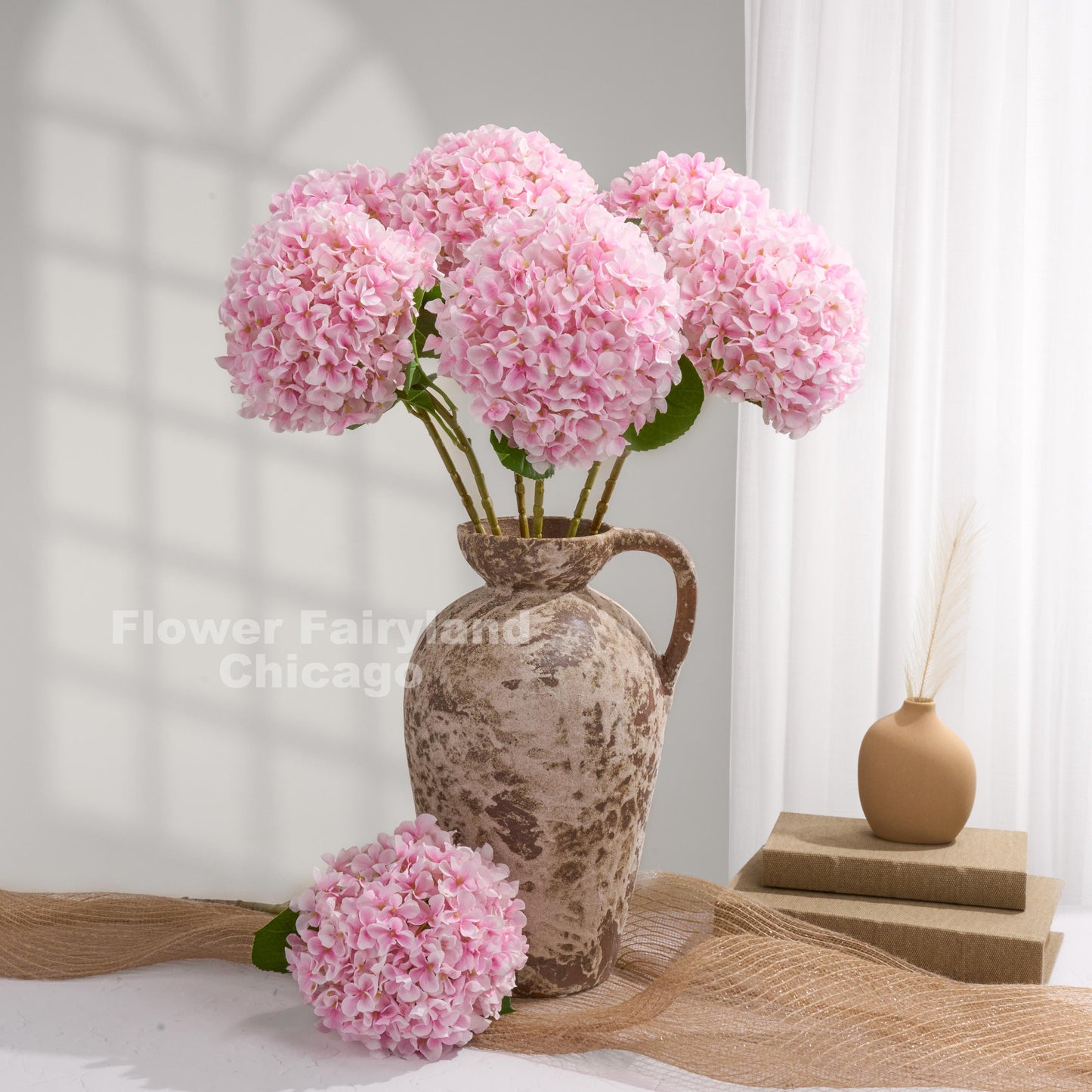Pink Grand Bloom faux hydrangeas styled in a pitcher vase
