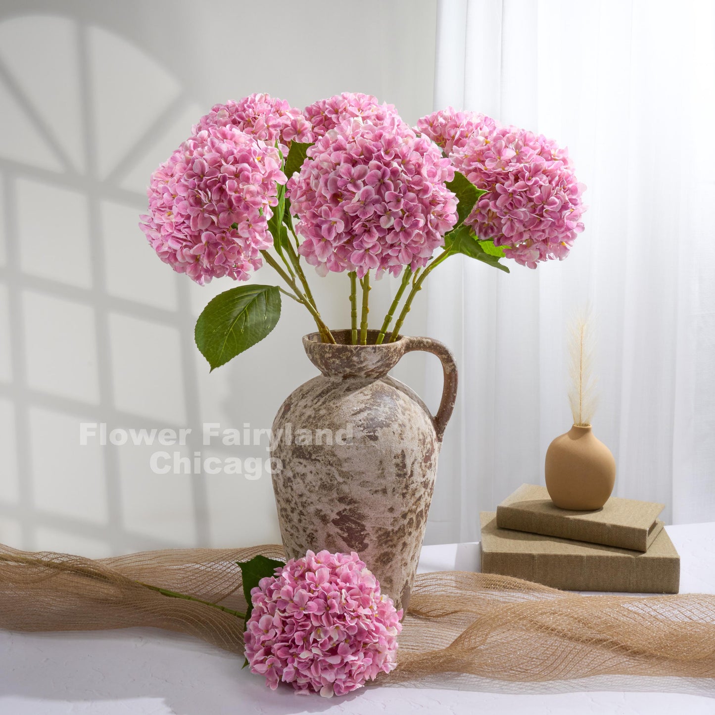 Purplish pink Grand Bloom faux hydrangea arrangement in a pitcher