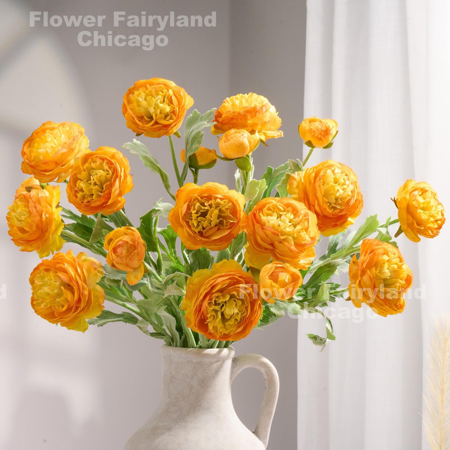 Light gradient orange 3 head ranunculus stems in vase