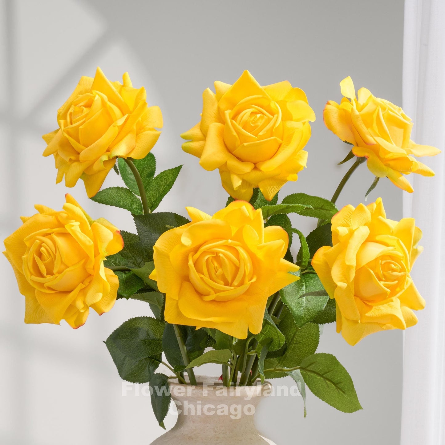 Yellow real touch full bloom roses in a vase