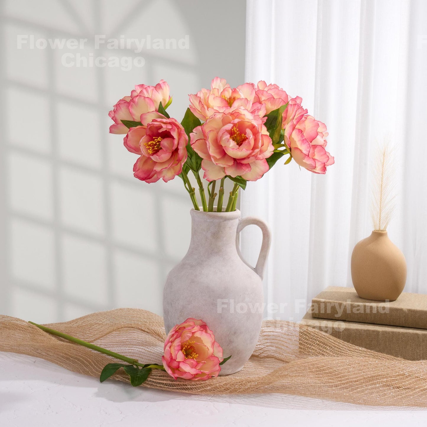 Coral faux peony arrangement in a vase