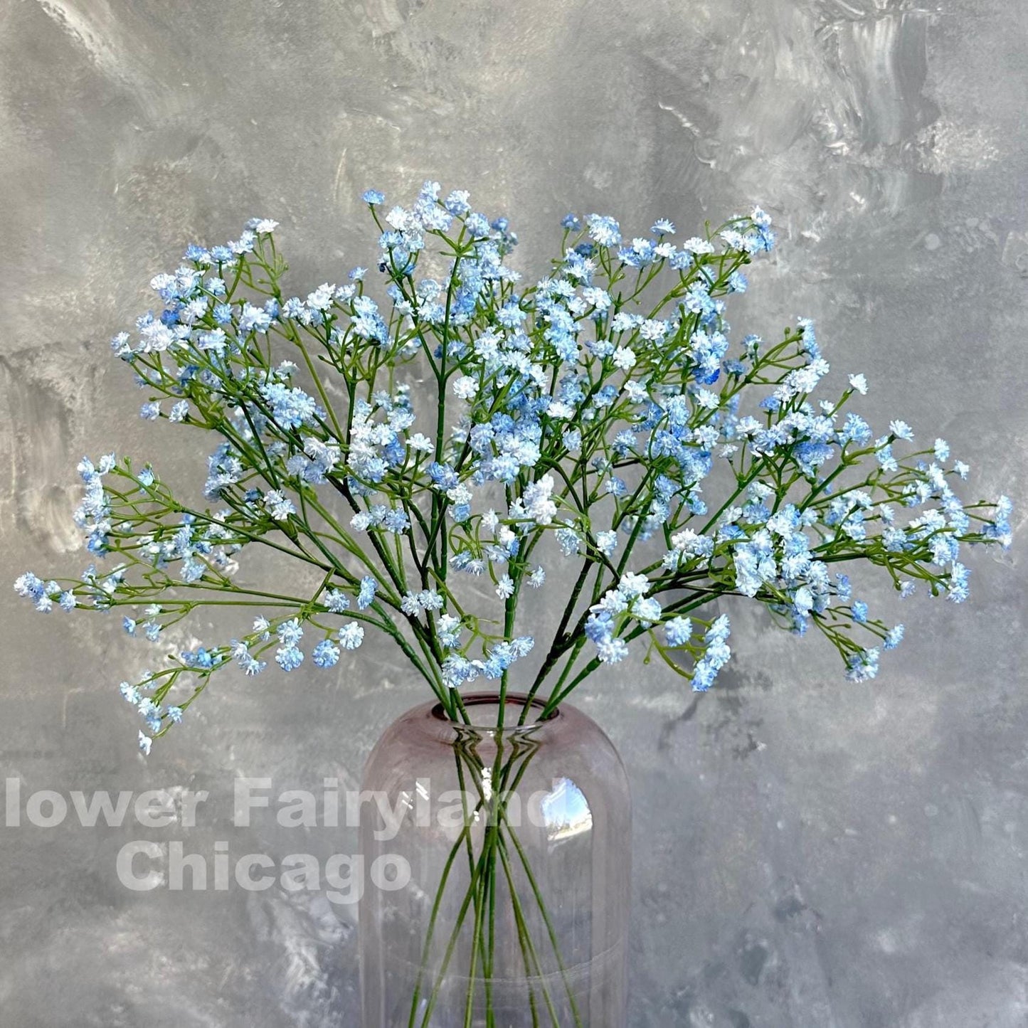 Light blue faux baby's breath styled in a vase
