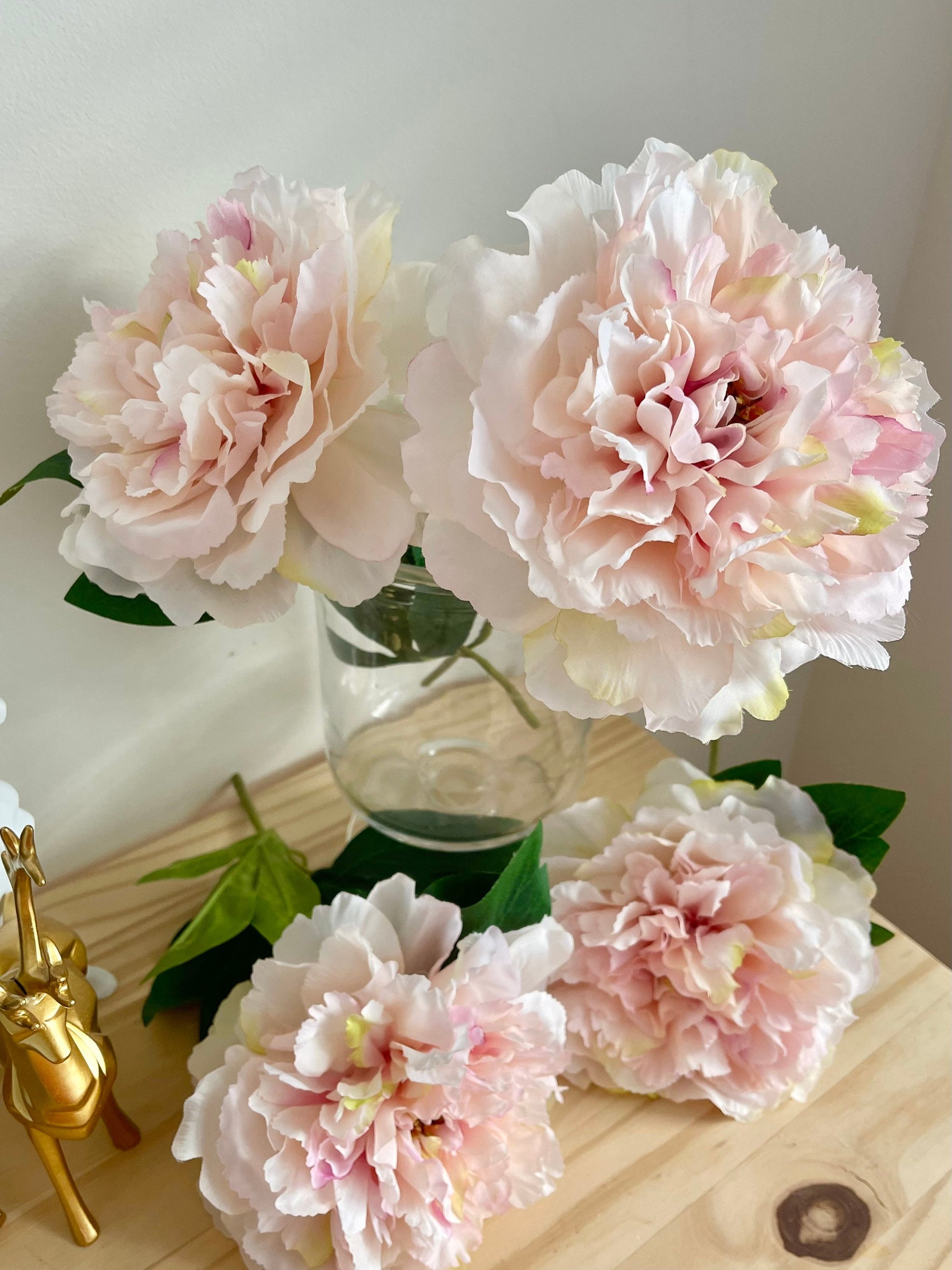 Light pink huge peony blooms styled with a vase