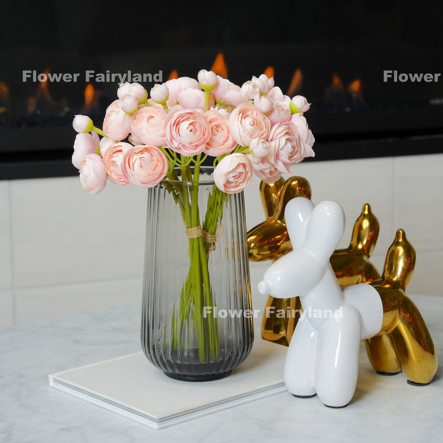 Soft pink mini ranunculus styled in a vase