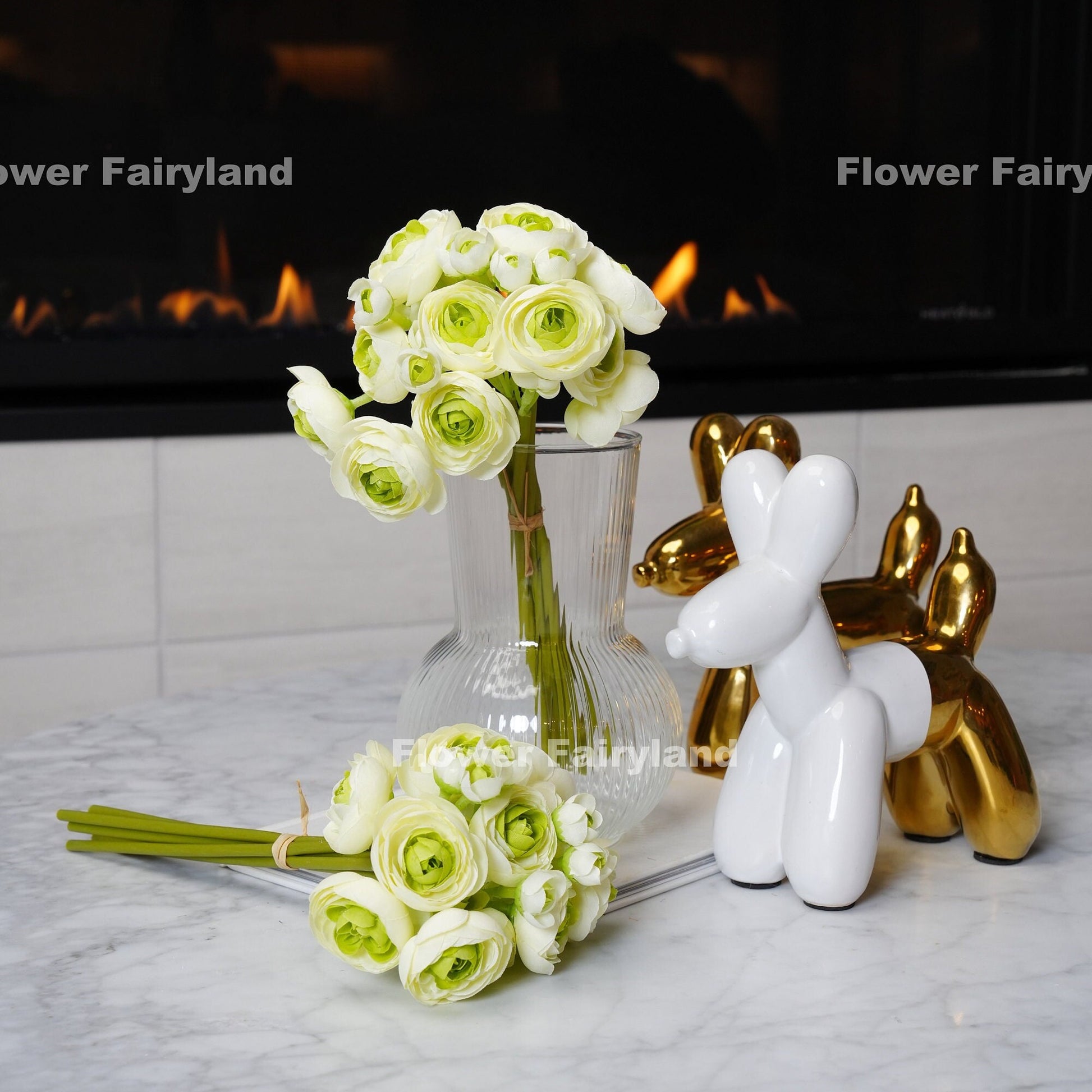 White and green mini ranunculus styled in a vase