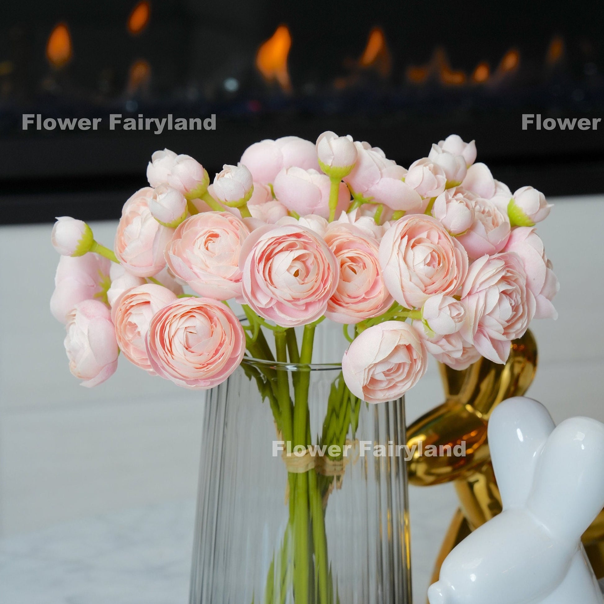 Soft pink mini ranunculus bundle held in hand