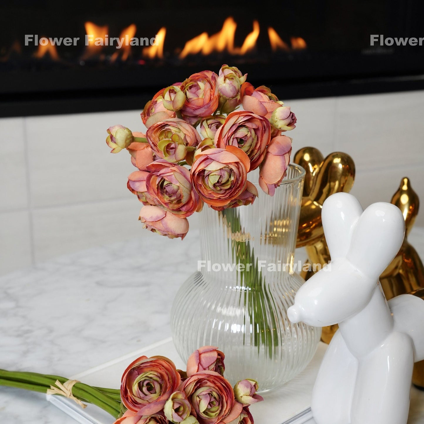 Pale burnt orange ranunculus bundle held in hand