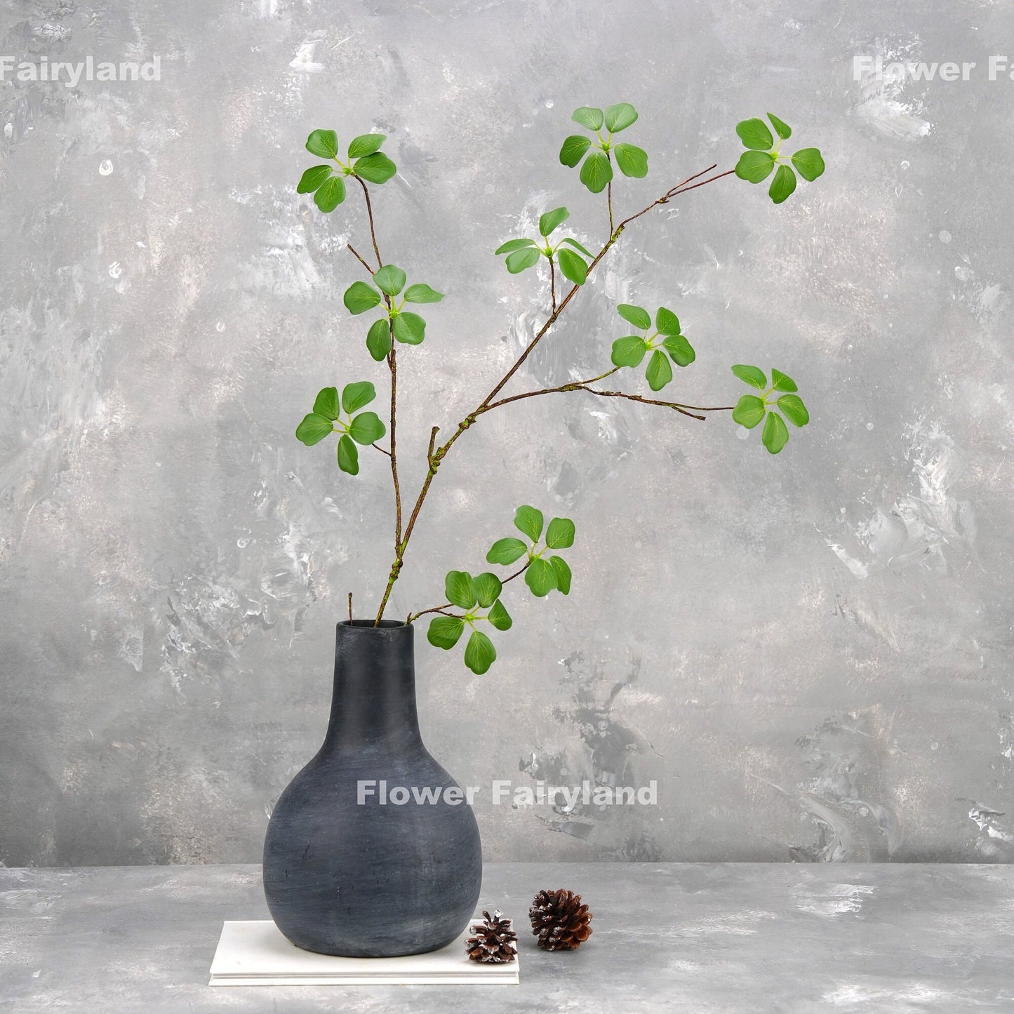 Faux Pieris Japonica stem in a dark vase