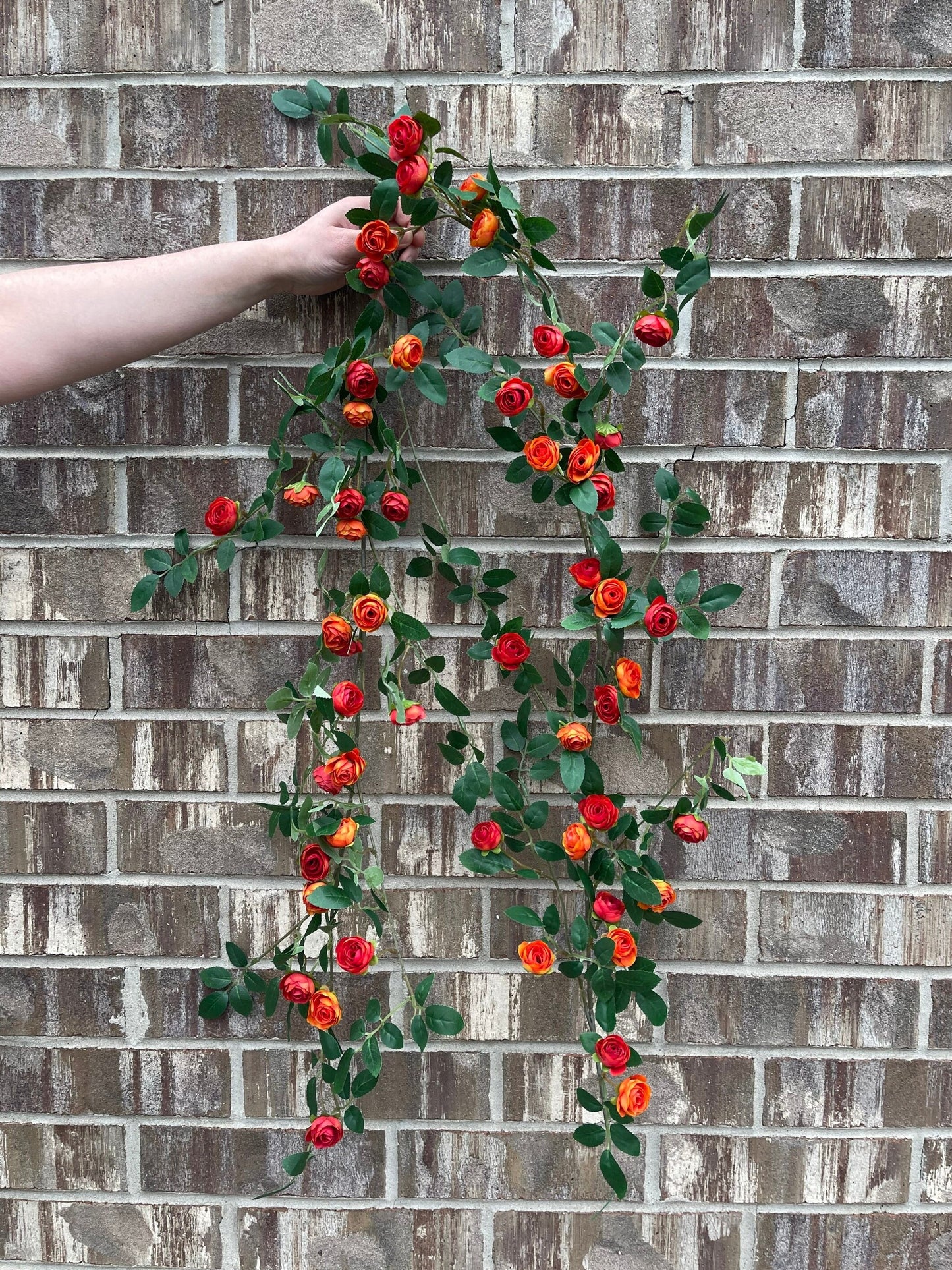 Red orange rose garland draped in decor