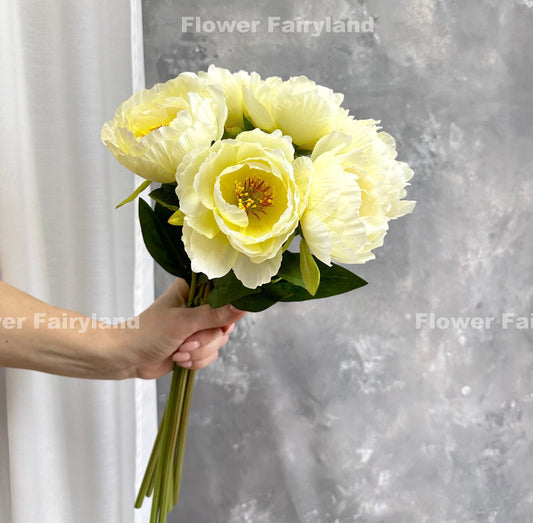 Yellow faux peony bouquet held in hand