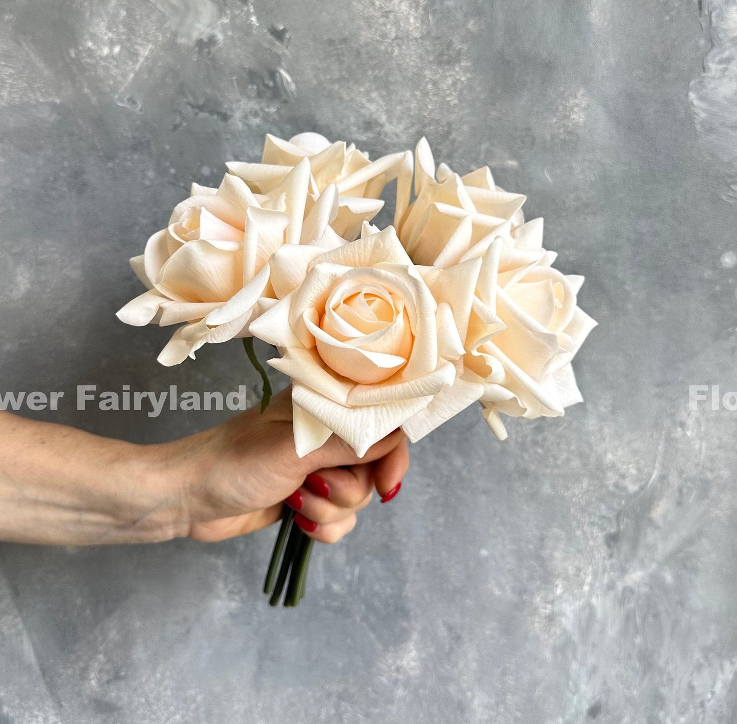 Soft peach real touch rose bouquet held in hand