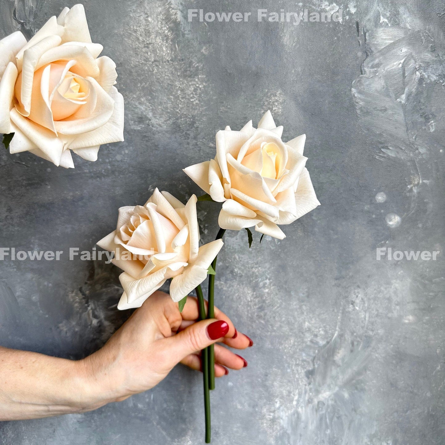 Peach real touch roses close-up in hand