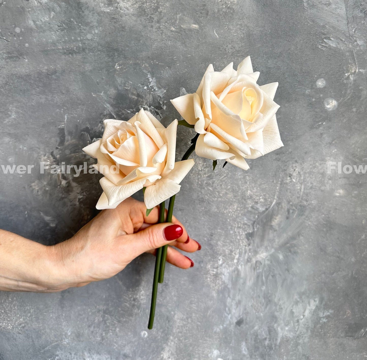 Soft peach roses held showing stems