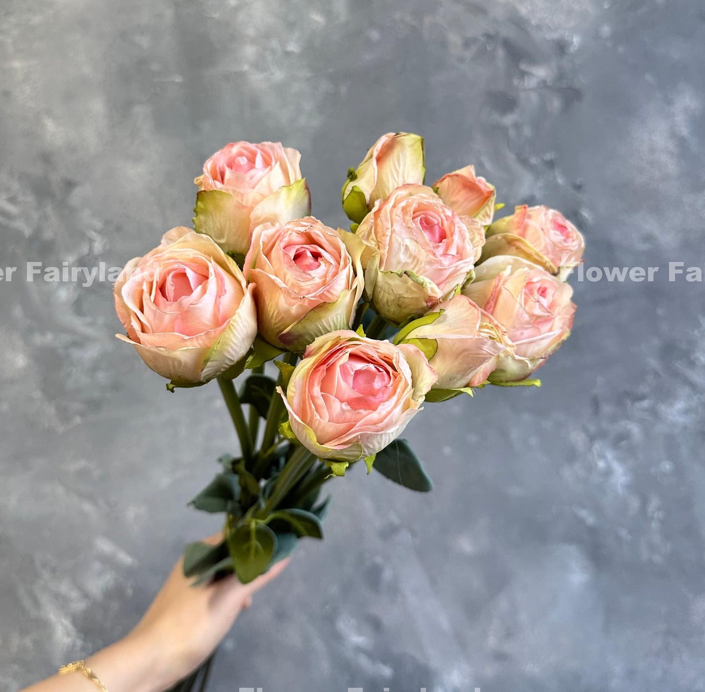 Light pink dried look roses in a vase