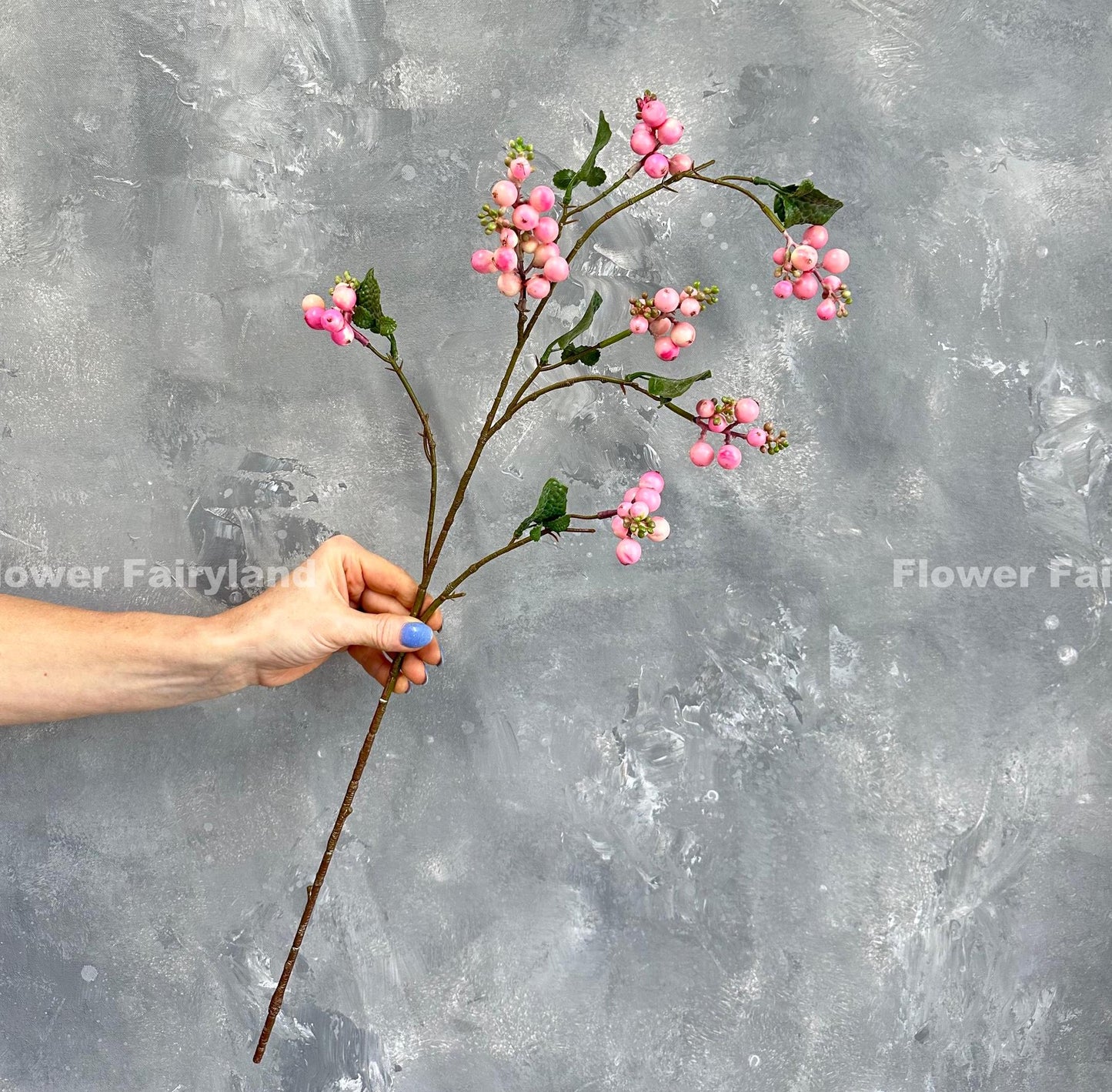 Pink snowberry branch styled in vase