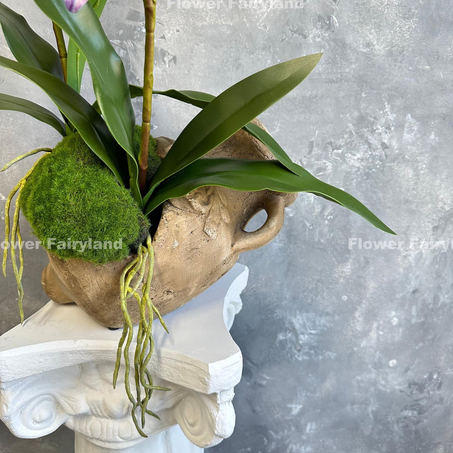 Purple faux cattleya orchid on moss