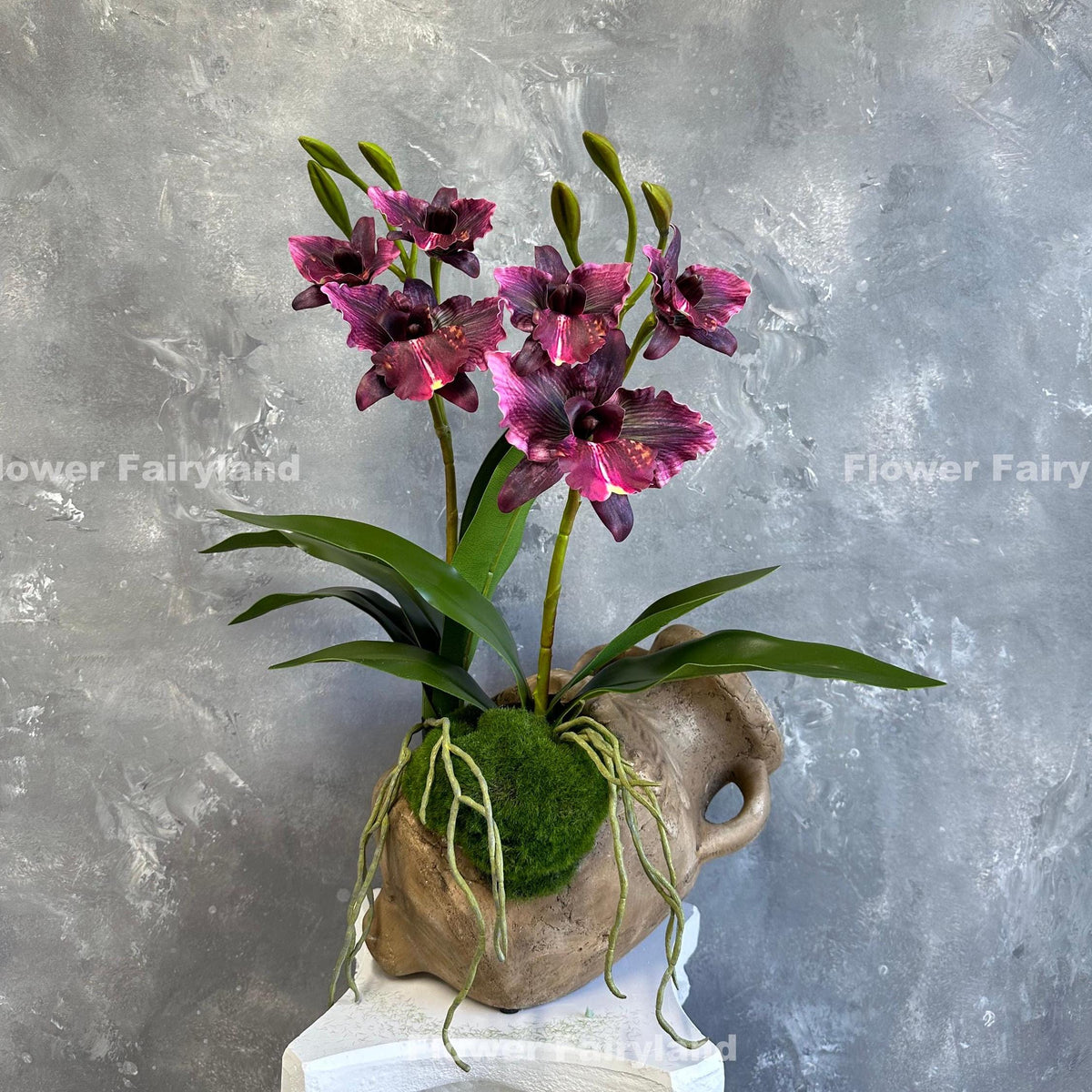 Faux cattleya orchid in dark magenta with leaves and roots