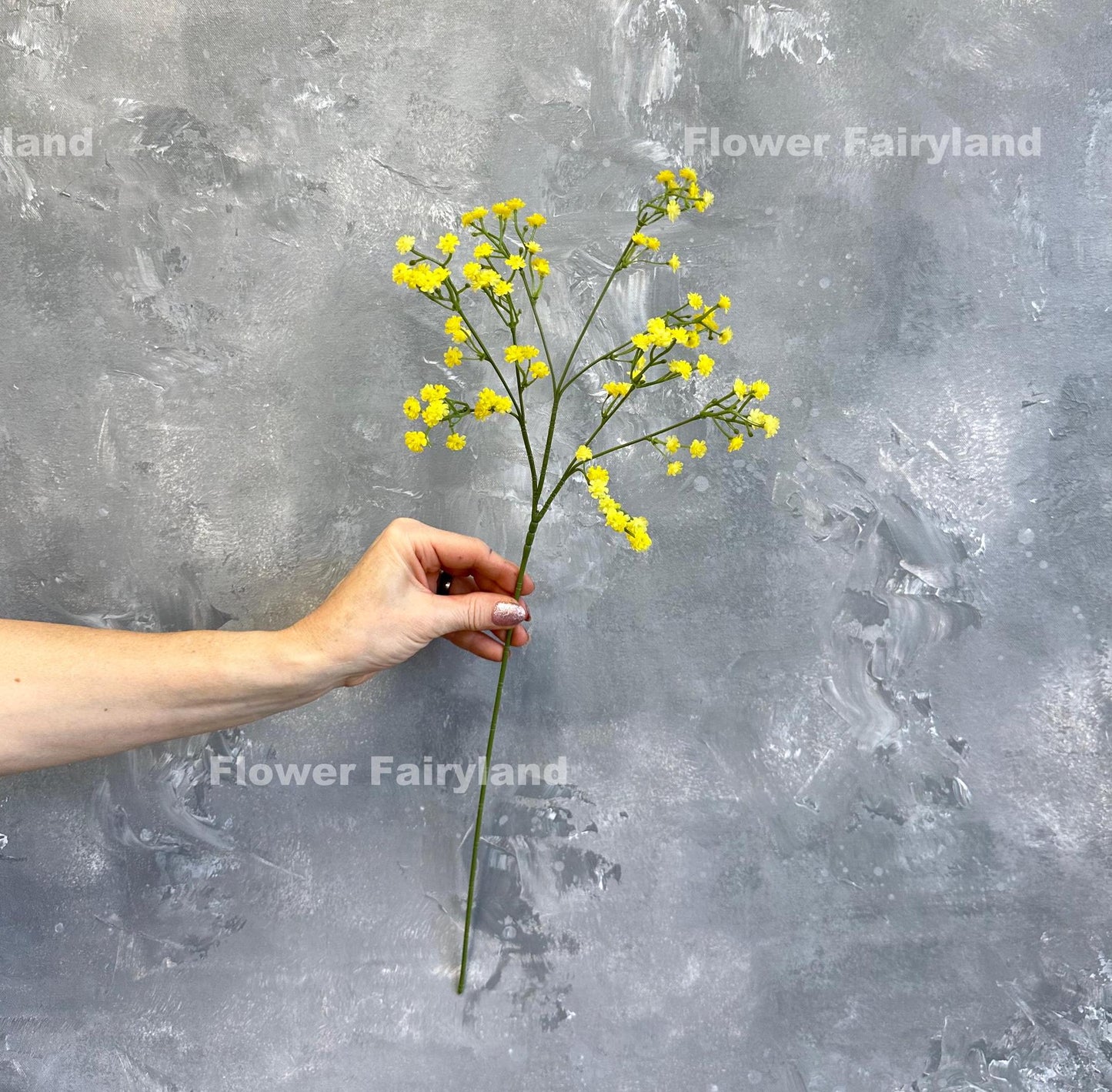 Yellow faux baby's breath styled in a vase