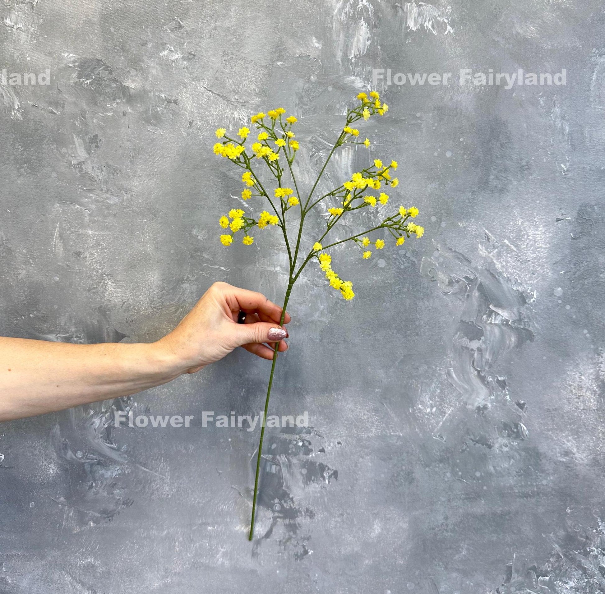 Yellow faux baby's breath styled in a vase