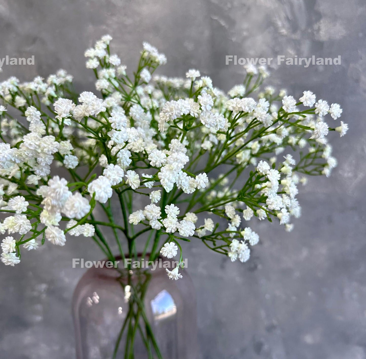 White faux baby's breath styled in a glass vase