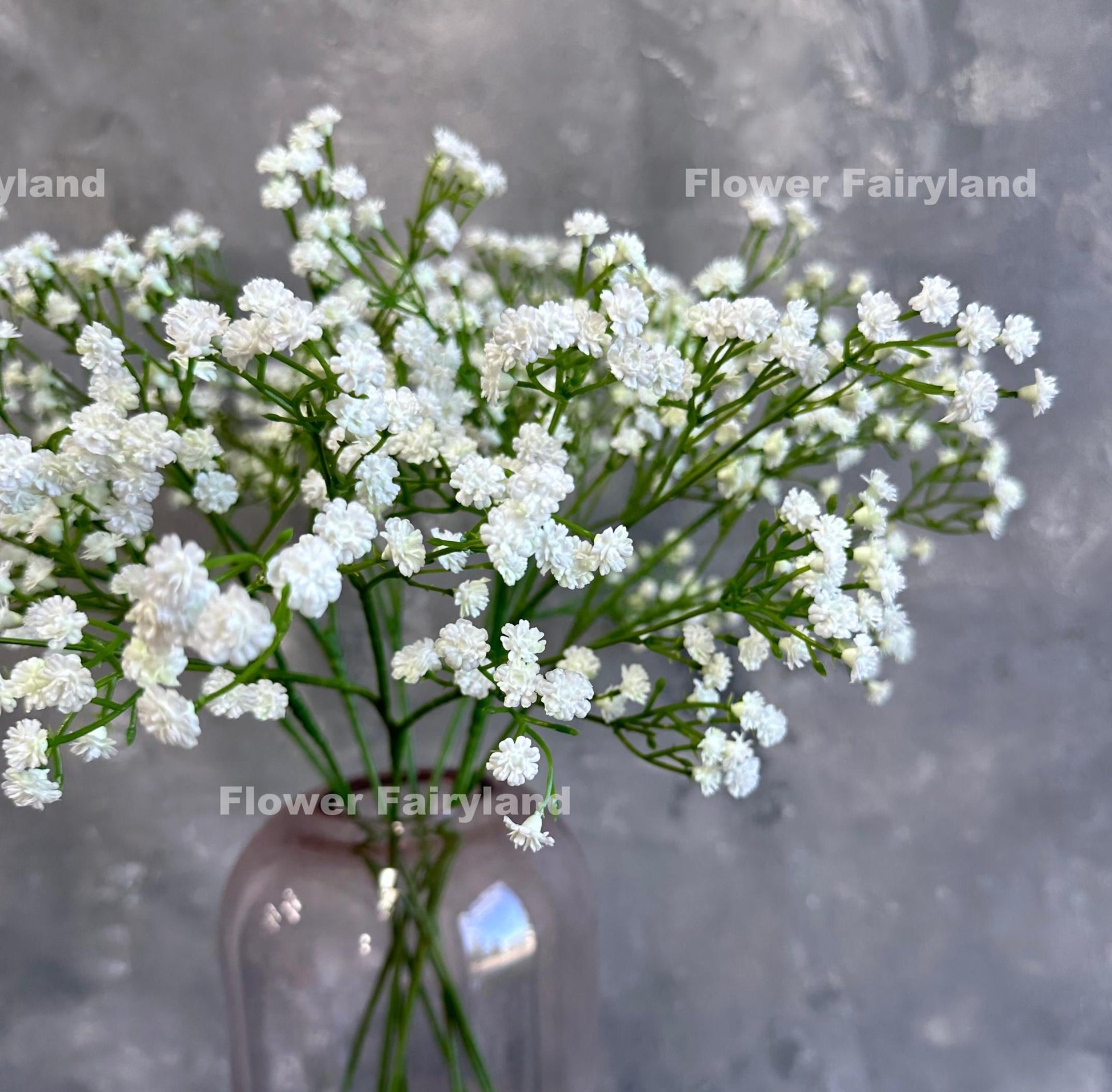 White faux baby's breath styled in a glass vase