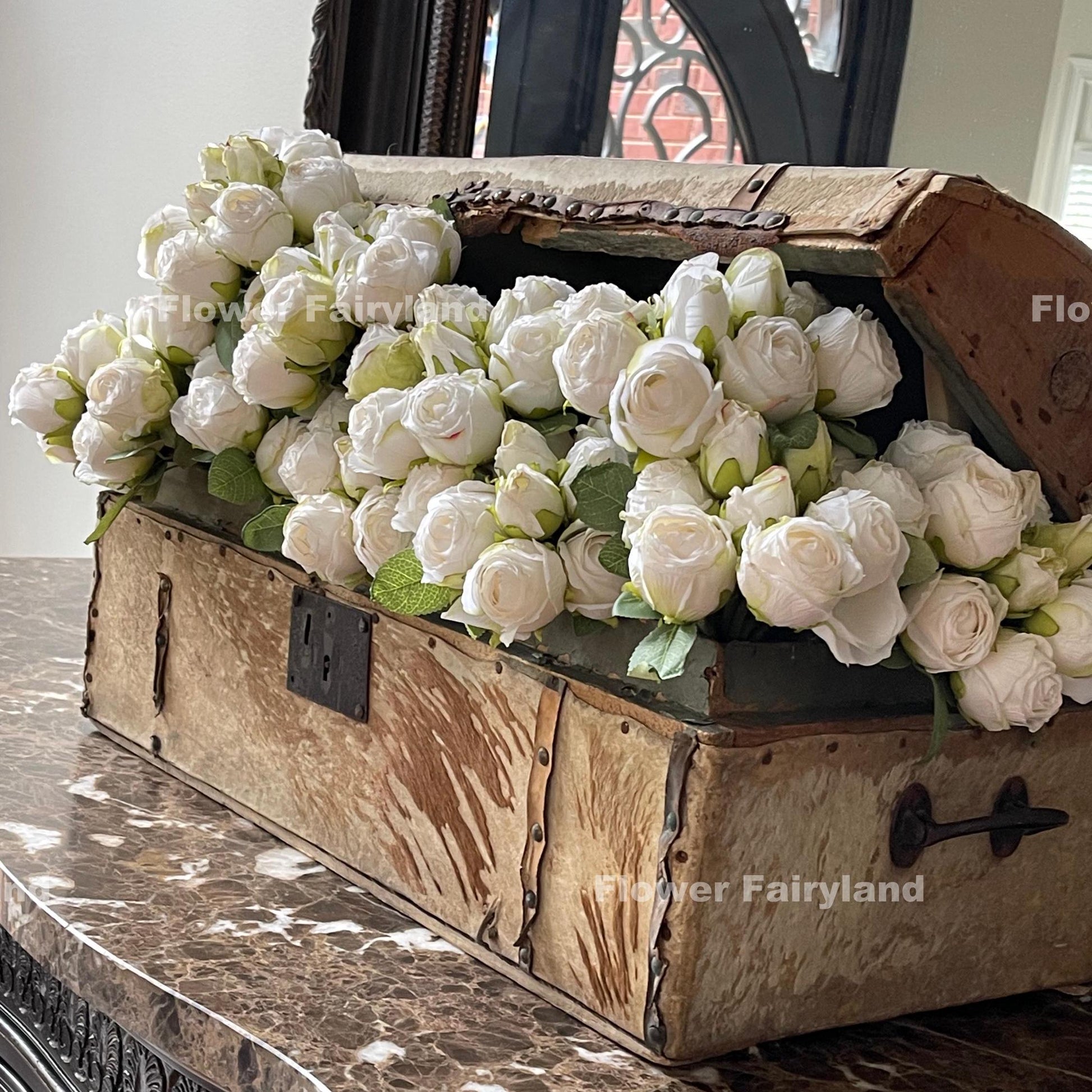 White dried look roses in a vase
