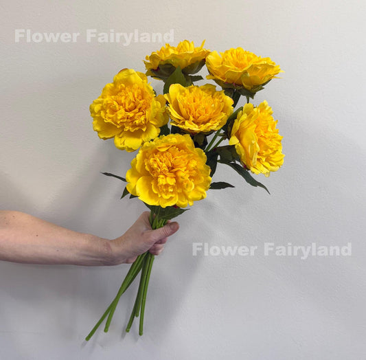 Yellow real touch peonies arranged in a vase
