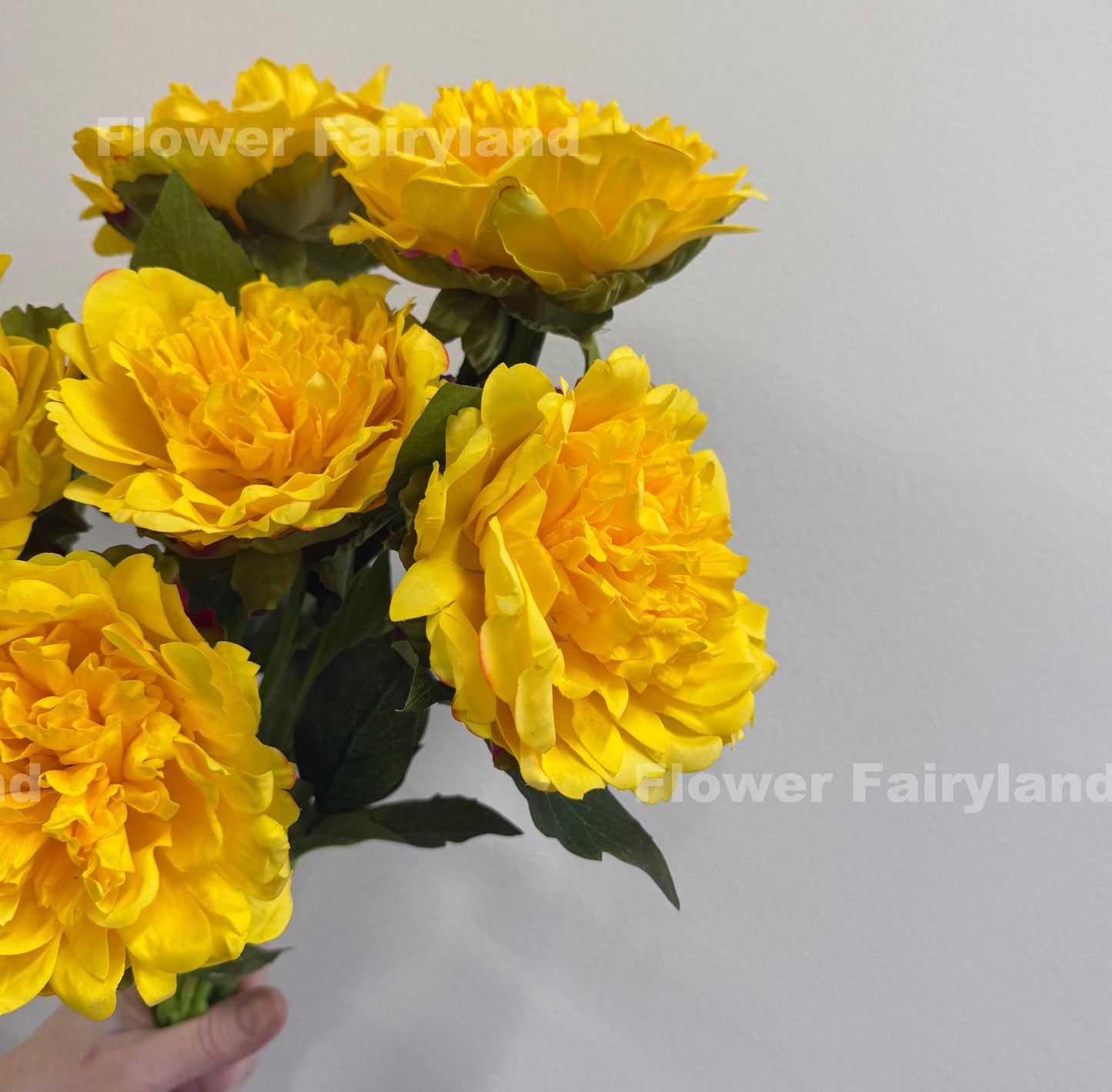 Yellow faux peonies styled in a home decor scene