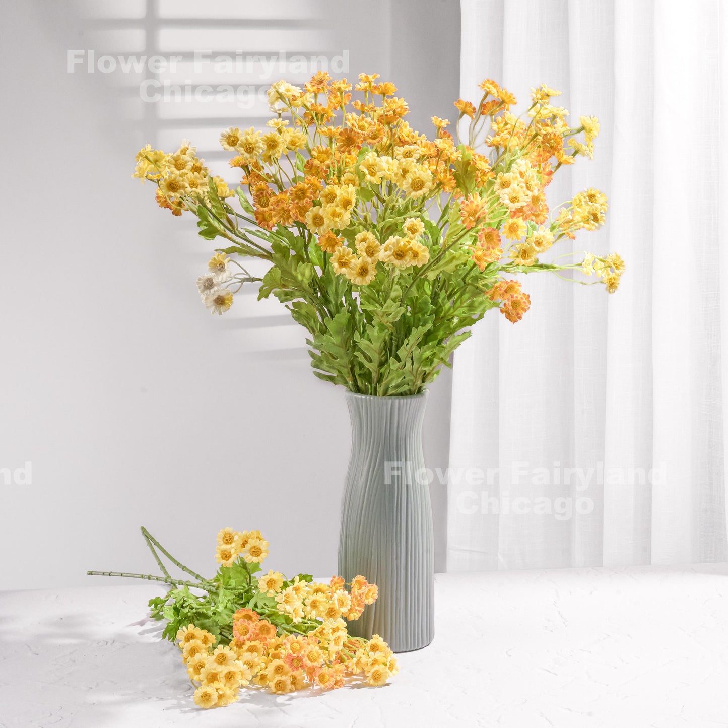 Yellow faux chamomile daisy blooms in a vase