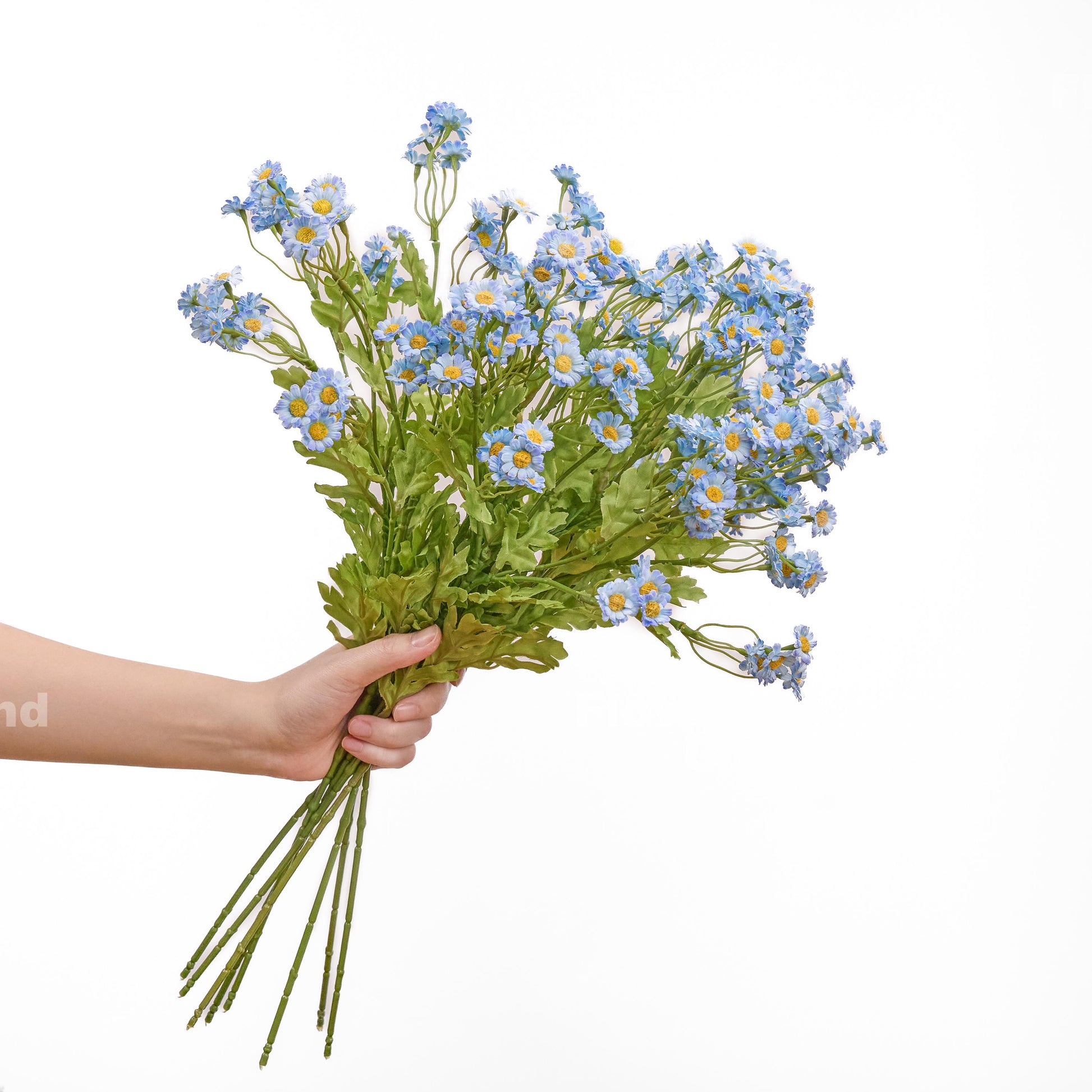 Blue faux chamomile bouquet held in hand