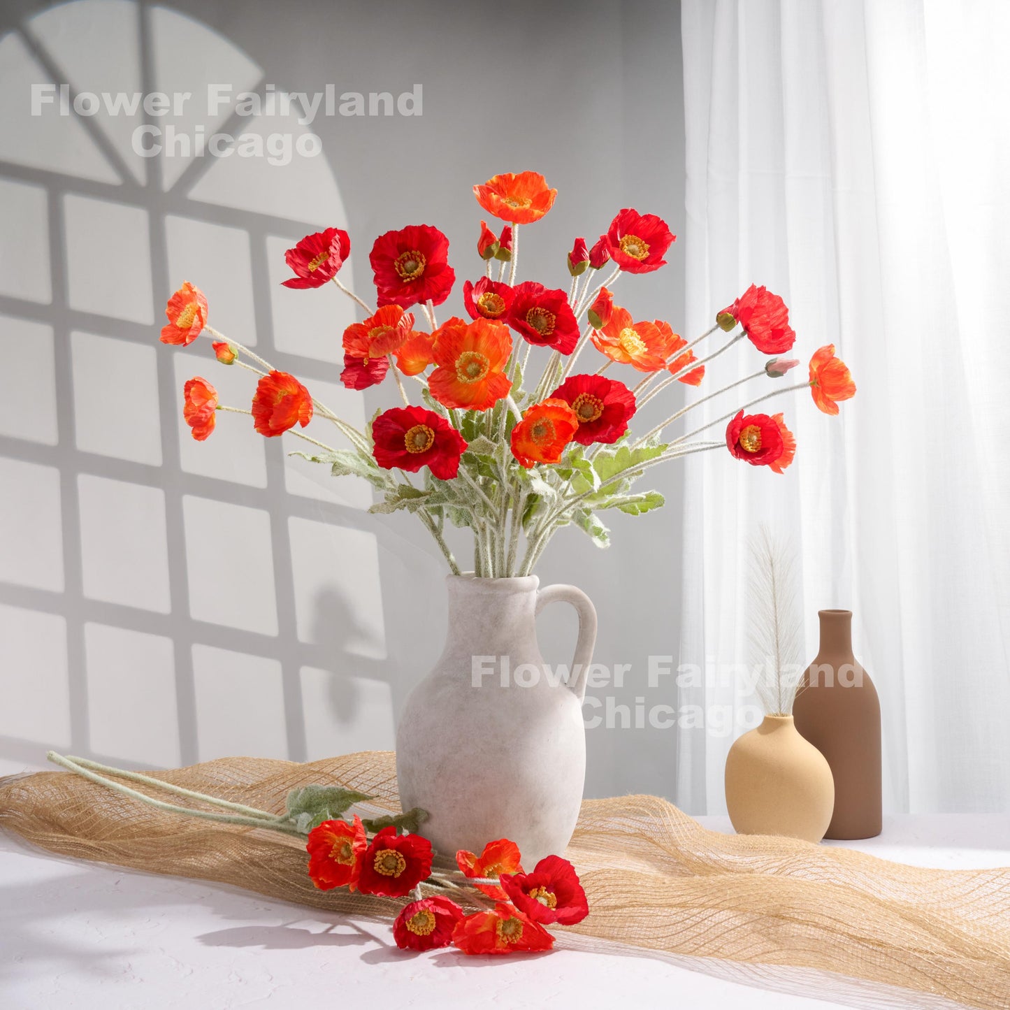 Coral red poppy arrangement in vase
