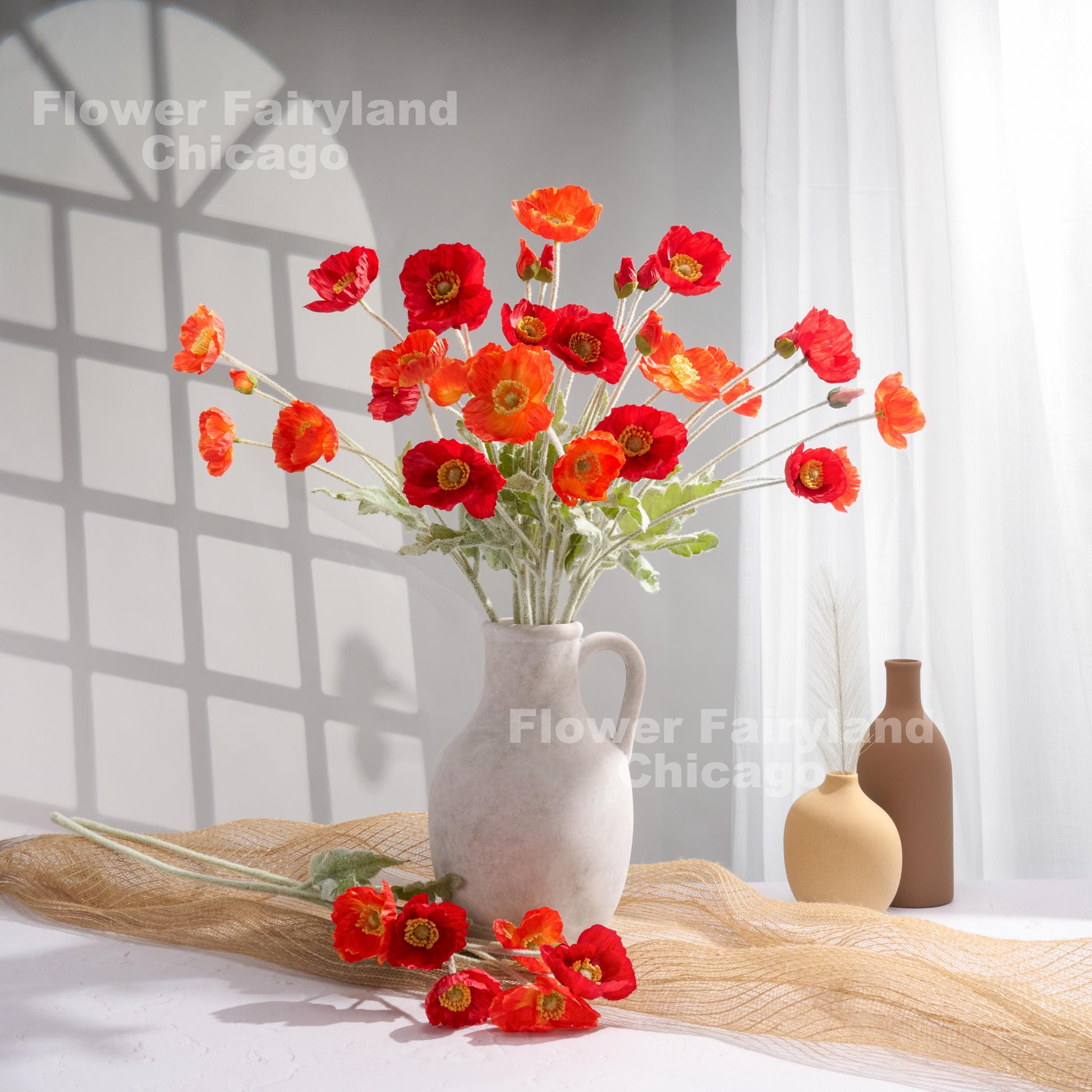Coral red poppy arrangement in vase