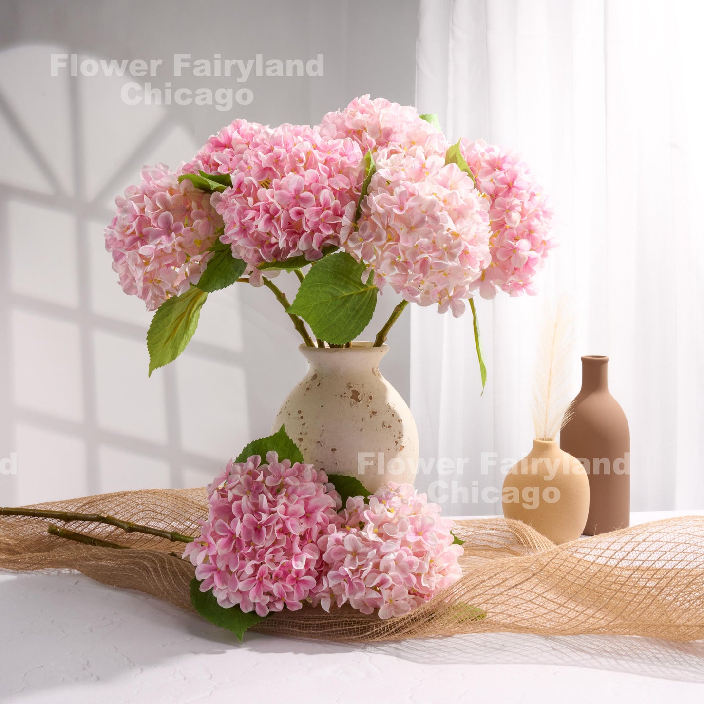 Pink faux hydrangeas in a pitcher vase