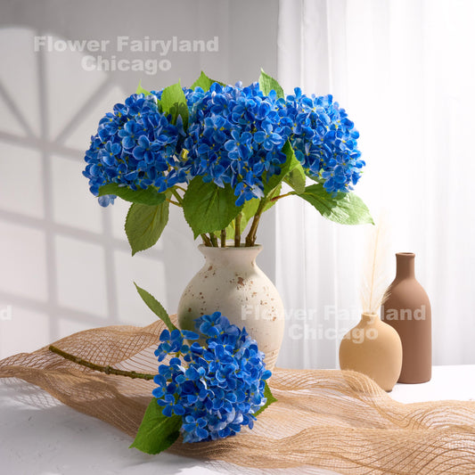 Dark blue faux hydrangea arrangement in a vase