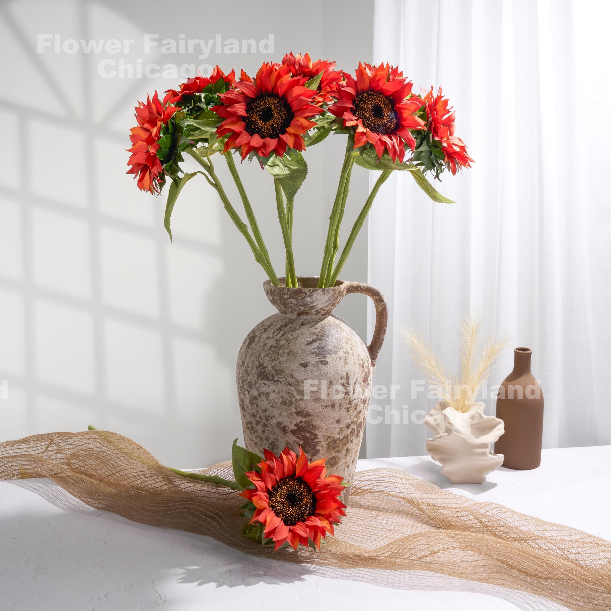 Fire red real touch sunflowers styled in a vase