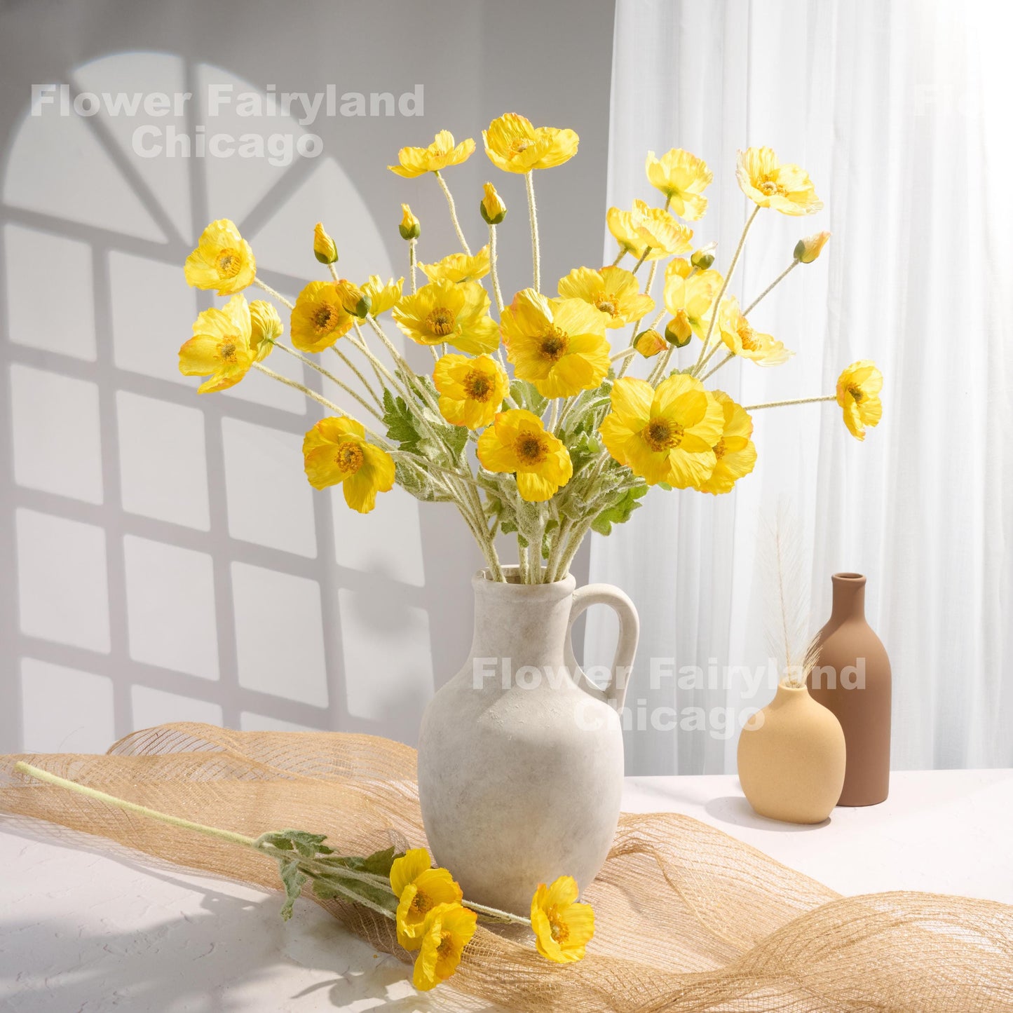 Yellow faux poppy stems in a vase