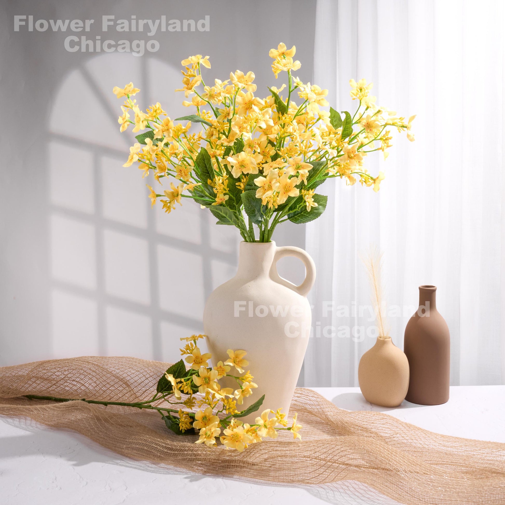 Yellow faux Vernicia flowers styled in a vase