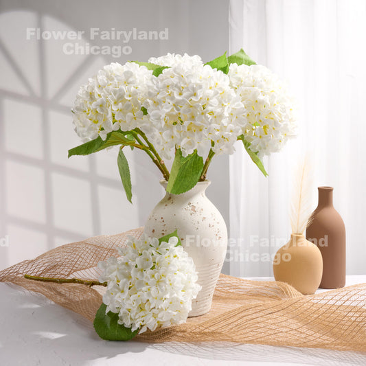 White faux hydrangea arrangement in a vase