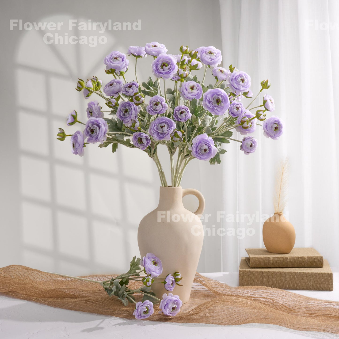 Soft purple faux ranunculus stems in a vase