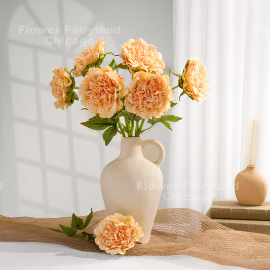 Peach faux peonies styled in a home decor scene