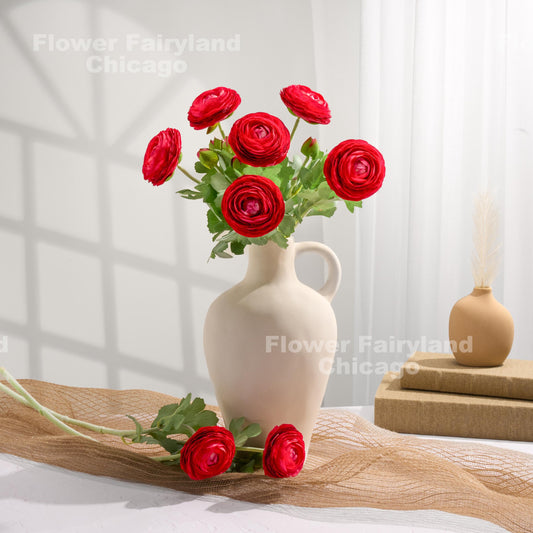 Red faux ranunculus stems in a vase