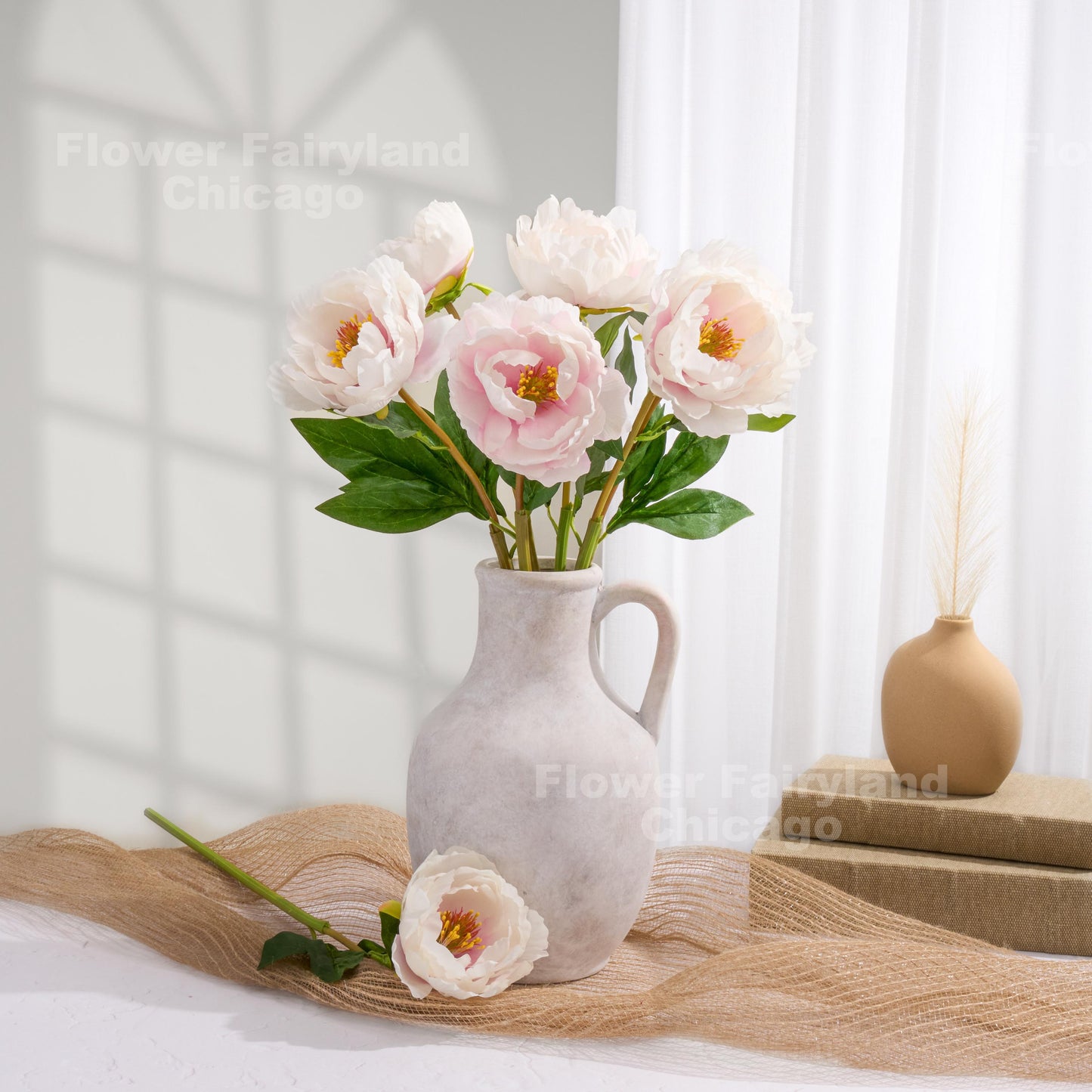Mauve ivory faux peony arrangement in a pitcher vase