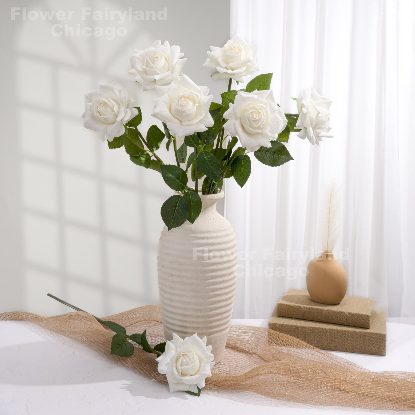 White roses styled in a home decor scene