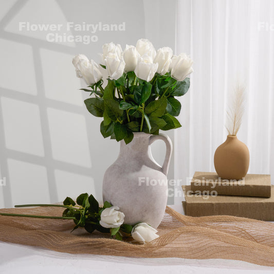 White rose buds styled in a cream vase